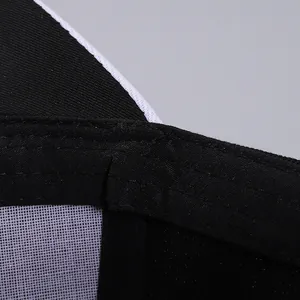 Macro detail of the baseball cap's inner black fabric and fine white mesh lining