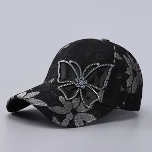 Close-up of black lace baseball cap featuring rhinestones on a silk butterfly knot