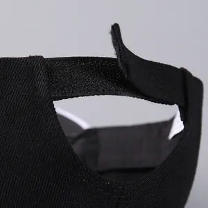 Close-up of adjustable velcro strap and premium twill fabric on black baseball cap