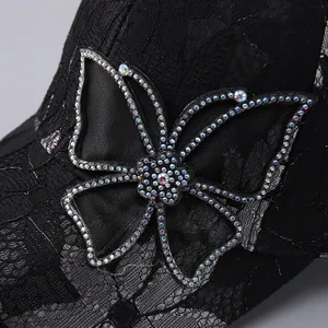 Black lace baseball cap with sparkling rhinestone butterfly and floral embroidery detail