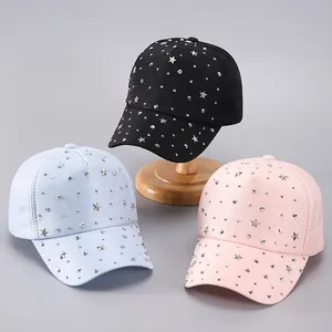 Detailed star rivets and silver studs on black, blue, and pink sparkle baseball caps