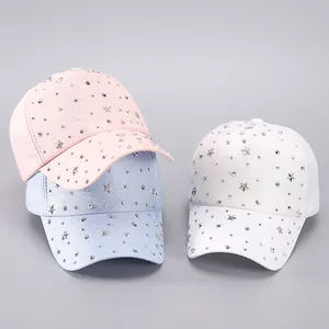Detail of pink, blue and white baseball caps with silver star and round metal studs
