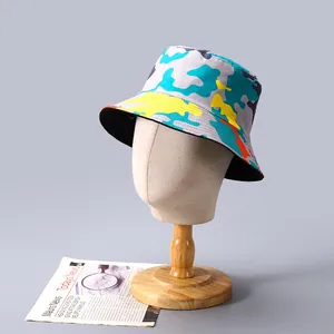 Détail d'un chapeau bob camouflage avec imprimés bleu et jaune vifs sur toile de coton