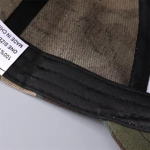 Detail view of inner sweatband stitching and size label of the camouflage baseball cap