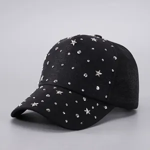 Detailed view of black baseball cap decorated with silver star and dot metallic rivets