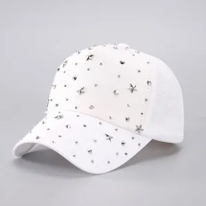 Close-up of white baseball cap with silver metal studs and 3D star-shaped ornaments