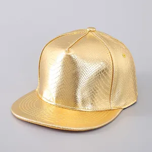 Close-up of golden PU leather snapback hat with metallic snake pattern texture