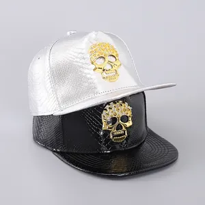Detailed view of snake texture PU leather baseball cap with a gold studded skull emblem