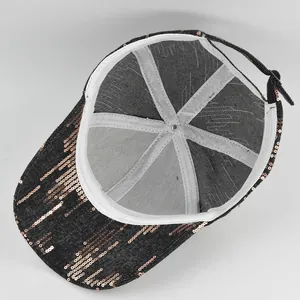 Detail of sequin baseball cap interior showing white seam binding and metal buckle
