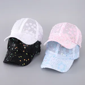 Detail of sequined mesh baseball caps in white, black, pink and light blue with floral patterns
