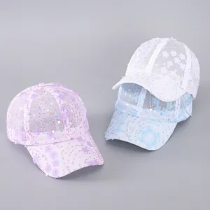 Detailed view of mesh baseball caps featuring delicate floral lace and sequins
