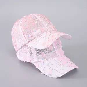Detail of pink mesh baseball caps featuring 3D floral decorations and sparkling sequins