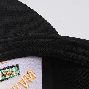 Detailed close-up of inner sewing and embroidered logo tag on the black baseball cap