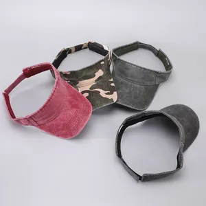 Detail of four washed cotton sun visors with adjustable straps in various colors