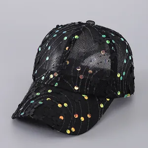 Detailed close-up of floral appliques and colorful sequins on a mesh baseball cap
