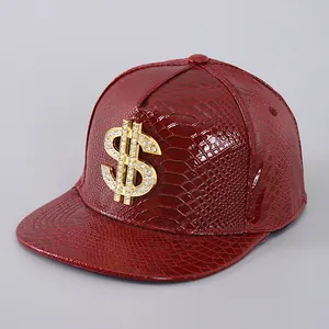 Detail of red faux crocodile leather baseball cap with diamond-encrusted gold dollar sign