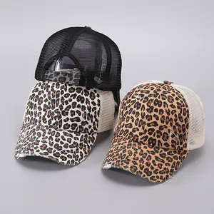 Detailed side view of ponytail baseball cap with leopard print and distressed mesh design