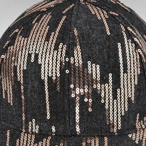 Macro detail of rose gold sequins on denim baseball cap with stylish vertical fringe pattern
