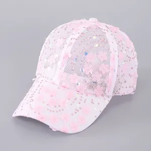 Detailed view of pink mesh baseball cap with 3D floral patches and sequins