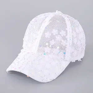 Close-up of white lace baseball cap with floral embroidery and laser sequins