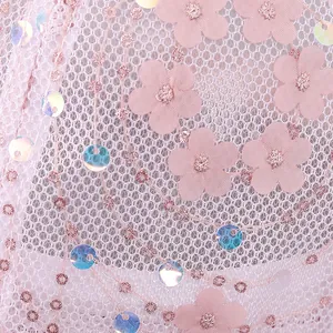 Close-up of pink mesh baseball cap featuring 3D floral appliques and iridescent sequins