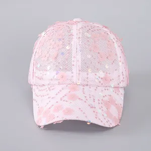 Close-up of pink mesh baseball cap with 3D floral appliqués and iridescent sequins