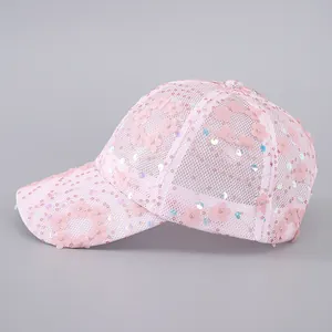 Detail of pink mesh baseball cap with 3D fabric flower appliques and colorful sequins