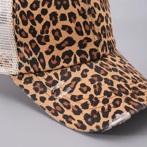 Close-up of leopard print baseball cap with distressed brim and breathable white mesh