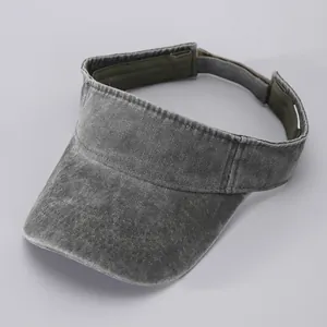 Detail of grey washed denim sun visor with reinforced stitching and adjustable strap