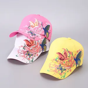Detailansicht der Blumenstickerei und glitzernden Pailletten auf bunten Baseballkappen