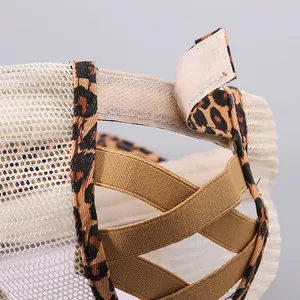 Detail of messy bun baseball cap back with leopard print and elastic criss-cross bands