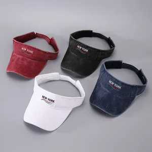 Detail of four colorful sun visors with New York embroidery and adjustable straps