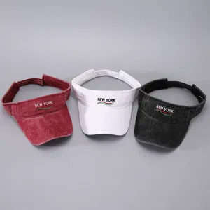 Detailed embroidery of NEW YORK lettering on summer cotton sun visor hats in three colors