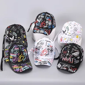 Detailed view of graffiti print baseball caps with long straps and streetwear patterns
