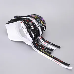 Detail of street-style baseball caps featuring long ribbons and colorful graffiti prints