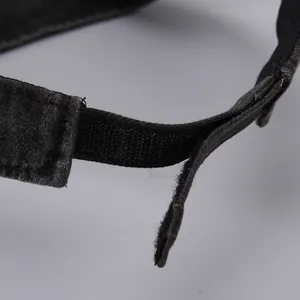 Close-up of adjustable hook and loop fastener with precise stitching on black sun visor