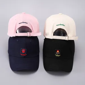 Detail of adjustable metal buckle and embroidered cotton fabric on four colored baseball caps