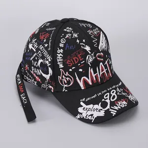 Detail of black cotton baseball cap featuring street style graffiti and long embroidered strap