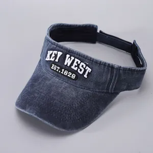 Detail of navy washed denim sun visor with white KEY WEST embroidery and EST.1828 patch