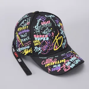 Detail of street style graffiti lettering and ribbon on a black cotton baseball cap