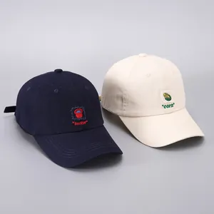 Close-up of navy and beige cotton baseball caps featuring small bucket and corn embroidery