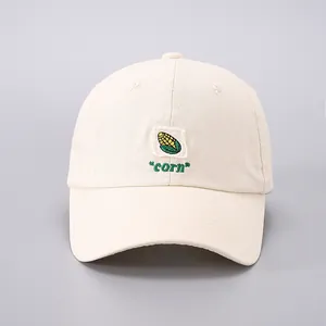 Detailed embroidery of a colorful corn stalk on a beige cotton canvas baseball cap