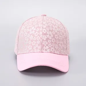 Detailed view of floral lace pattern and stitching on a light pink baseball cap