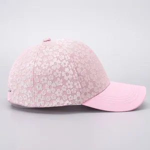 Detail of floral lace fabric and adjustable metal buckle on a pink women's baseball cap
