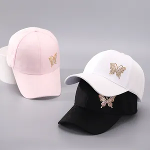Detailed close-up of butterfly baseball caps with floral jacquard and rhinestone accents