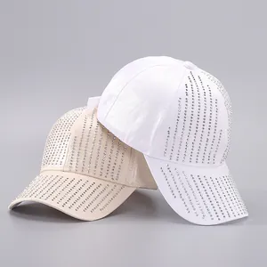 Detailed view of white and beige satin baseball caps with vertical rhinestone fringe patterns