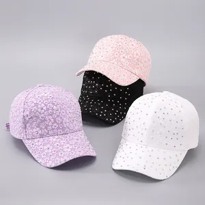 Macro view of multi-color baseball caps with rhinestone flowers and lace texture
