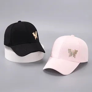 Close-up of butterfly baseball caps with rhinestone accents and jacquard texture