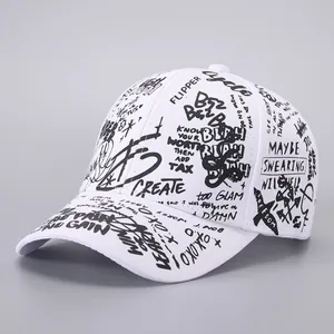 Detail of white cotton baseball cap with black graffiti print and various slogans