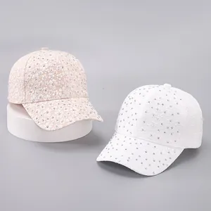 Detailed close-up of floral embroidery and sparkling rhinestones on baseball caps